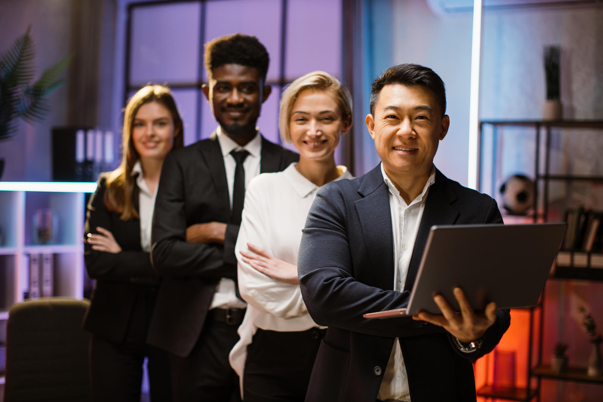 multiethnic-happy-company-workers-standing-in-a-ro-2024-12-10-03-54-34-utc.jpg